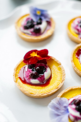 Lemon-tartlets-with-blueberry-compote-decorate-with-edible-flowers.jpg