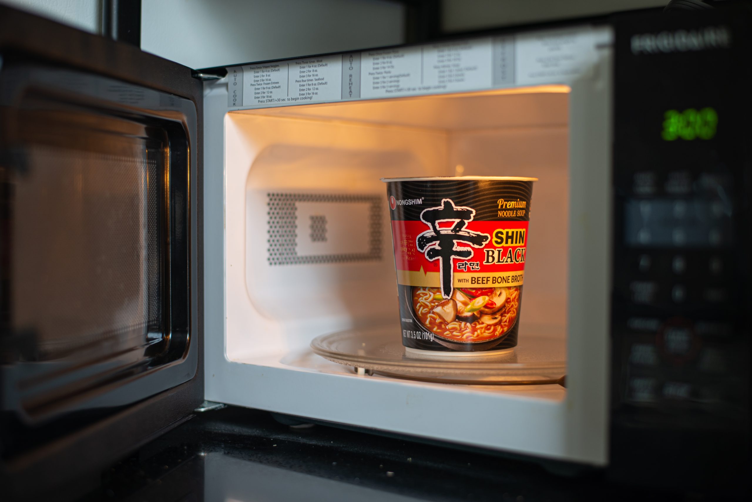 A Korean Nongshim cup noodle soup that is placed in microwave to be cooked